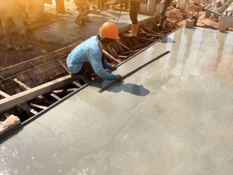 worker scraping the cement